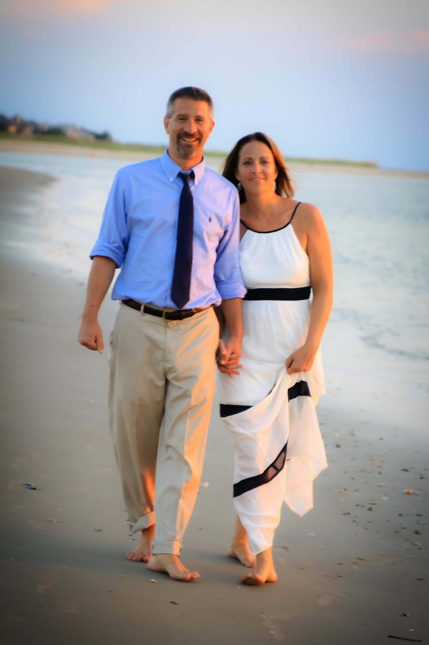 Beautiful Couple walking holding hands on the beach in Charleston, SC